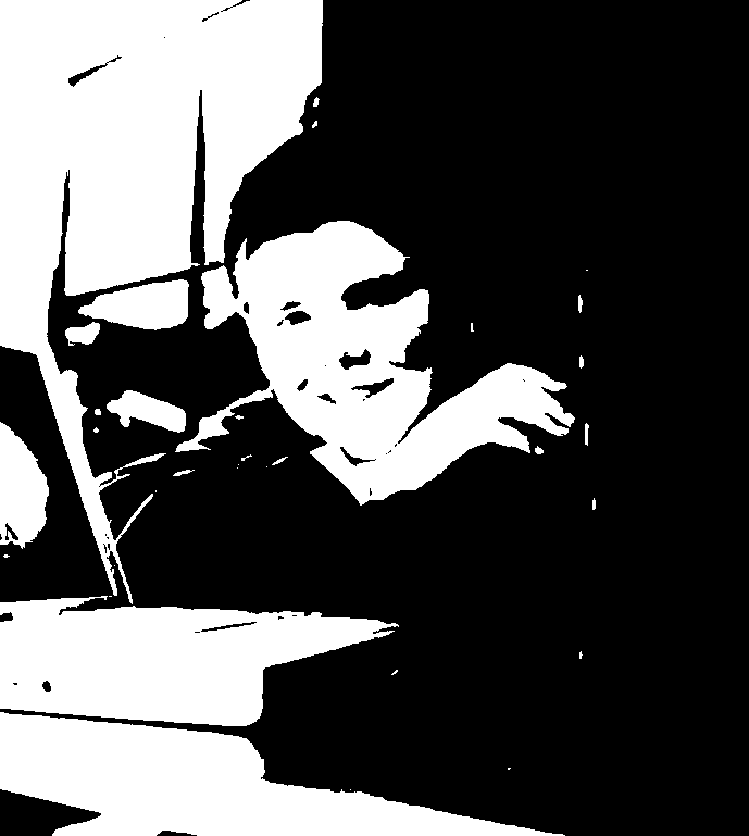 John Collison as a child with a laptop and a stack of encyclopedias